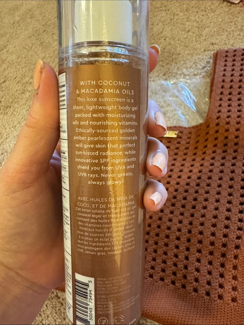 Kopari golden amber body glow sunscreen with rust knit tote